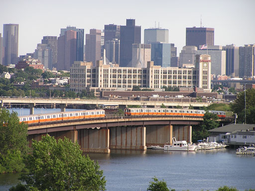 Photo of Two Orange Line rapid transit trainsets meet crossing the Mystic River