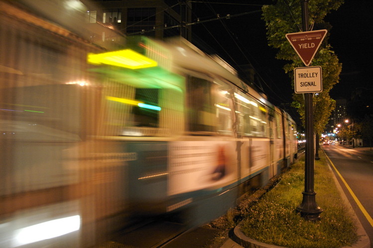 Photo of E Line train rushes past in a blur when the grass was still green. . . .