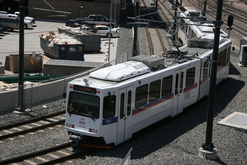 Photo of A Denver RTD car rounds the corner near Union Station